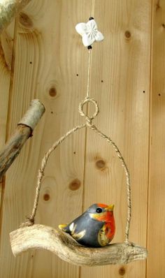 a bird on a branch with a star hanging from it