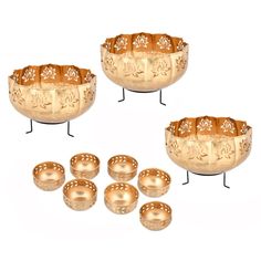 four brass bowls and six small dishes on stands