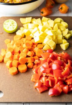 chopped up vegetables sit on a cutting board