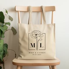 a tote bag sitting on top of a chair next to a potted plant