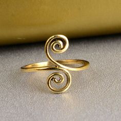 Unique Spiral Ring, Swirl Brass Ring, Double Coil Ring, Handmade Jewelry, Cool Ring, Gold Brass Ring, Adjustable Ring, Rings For Women 1. Please share your numbers (in personalization box ) as required for shipping address details, and it'll help us to contact you easily. And don't worry about the privacy, we'll keep it safe with us, So try to cooperate with us. :) 2.Customers' satisfaction is our biggest priority, please contact us with any questions/queries for future or existing orders, and we will do our best to make sure you are happy with your order. 3.Please make sure to add the correct address during checkout. You can return your purchased item within 15 days after successful delivery. We offer a 100% "Money Back Guarantee" if you are not satisfied with your purchase. Return charge Modern Twist Swirl Ring For Gift, Modern Twist Swirl Ring As Gift, Modern Twist Swirl Ring For Gifts, Gift Spiral Ring With A Modern Twist, Adjustable Swirl Ring As Gift, Calder Jewelry, Aluminum Wire Jewelry, Silversmithing Jewelry, Coil Ring