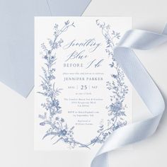 a blue and white wedding card with ribbon