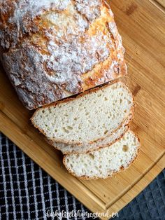 a loaf of bread sitting on top of a wooden cutting board