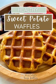 two waffles sitting on top of a wooden plate