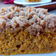 a close up of a piece of cake on a plate with other plates in the background