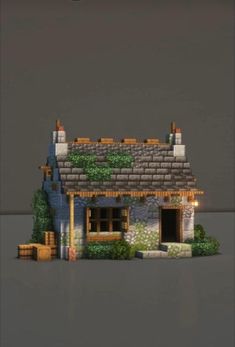 an image of a small house made out of lego blocks and bricks with plants growing on the roof