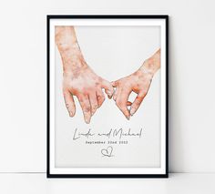 two hands holding each other with the words love and marriage written on them in black framed paper