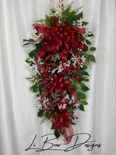 a red and white floral arrangement hanging on a wall