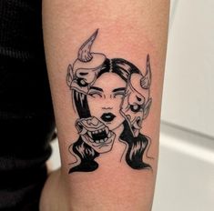 a woman's face with two horns on her arm, and an evil demon