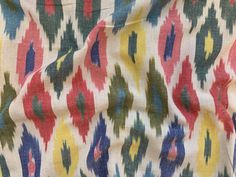 the fabric is multicolored and has an interesting pattern on it's surface