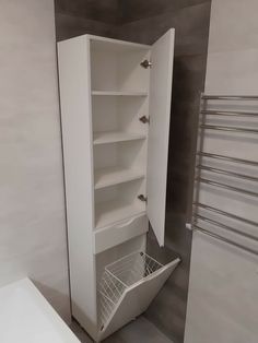 an empty white cabinet in the corner of a bathroom