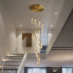 a modern living room with stairs and chandelier