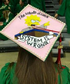 a person wearing a pink graduation cap with the simpsons on it