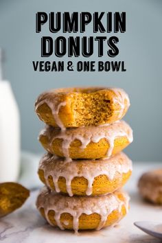 pumpkin donuts stacked on top of each other with icing drizzled over them