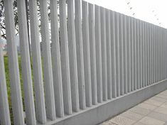 a white fence with birds flying over it