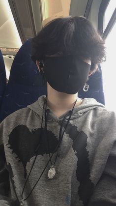 a person wearing a face mask on an airplane