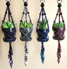 three hanging planters with plants in them and beads on the hooks attached to each other