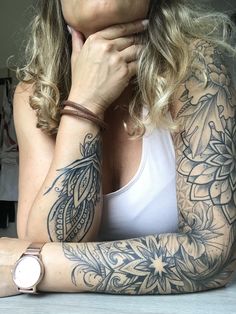 a woman with tattoos on her arms and arm