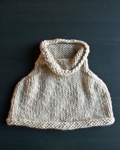 a white knitted hat sitting on top of a table