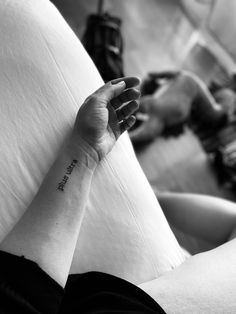 a woman's arm with a tattoo on it that reads, i love you