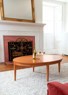 a living room with a fire place and a coffee table in front of the fireplace