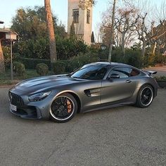 a silver mercedes sports car parked on the street