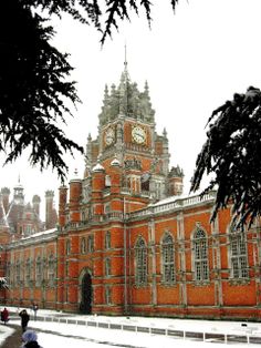 an old building with a clock tower in the snow