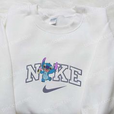 Introducing the Stitch Ice Cream x Nike Cartoon Embroidered Sweatshirt, a delightful collaboration that merges the beloved Disney character Stitch with the iconic Nike brand. This eye-catching sweatshirt features a meticulously embroidered design of Stitch enjoying a delicious ice cream, adding a touch of whimsy to your wardrobe. The Nike Inspired Embroidered Hoodie is a must-have for any sneakerhead or streetwear enthusiast. With its stylish embroidered Nike logo and comfortable fit, this hoodi Custom Nike Sweatshirt Christmas, Christmas Crewneck Sweatshirt Nike, Nike Christmas Clothes, Nike Costum Sweatshirt, Christmas Crewneck Nike, Stitch Sweatshirt Nike, Christmas Nike Crewnecks, Custom Christmas Nike Sweatshirt, Pull Nike Stitch