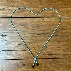 a heart - shaped string attached to a wooden floor