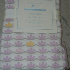 a baby's diaper with its tag attached to the side of it, sitting on top of a bed