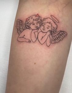 an angel tattoo on the arm with two cherubs holding each other's hands