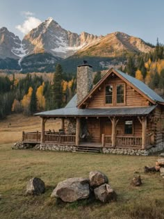 a log cabin in the mountains with a stone chimney