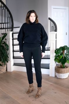 StyleDahlia wearing elevated sweatshirt, black pants and leopard booties. #styledahlia #allblackoutfits #elevatedsweatshirt #styleover40 #over40style #leopardbooties #outfitinspriation