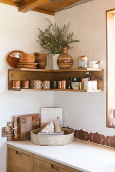 a kitchen with wooden shelves filled with dishes