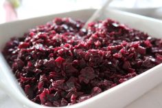 a white bowl filled with cranberry sauce on top of a table