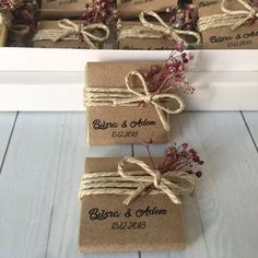 wedding favors wrapped in brown paper and tied with twine, sitting next to each other