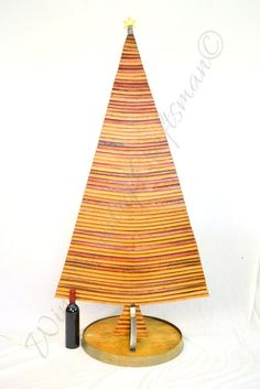 a small wooden christmas tree sitting on top of a table