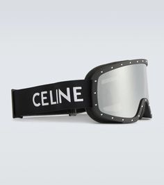 a pair of ski goggles sitting on top of a black strap with white lettering