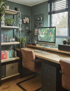 a home office with two desks and bookshelves in front of the window