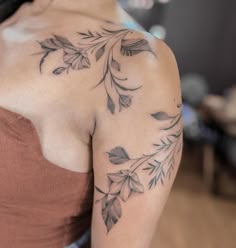 a woman with a tattoo on her shoulder