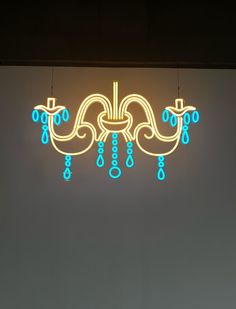 a chandelier with blue and yellow lights hanging from it