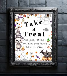 a framed halloween poster on a brick wall with the words, take a treat and leave some treats for all to see