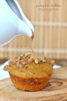 a muffin is being drizzled with maple syrup