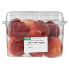 a plastic container filled with peaches on top of a white background and labeled price label