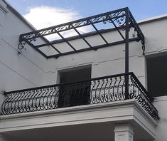 a balcony with wrought iron balconies and windows