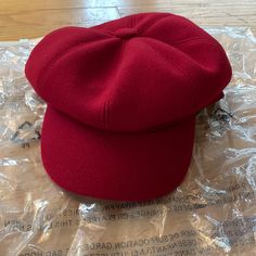 a red hat sitting on top of a plastic bag