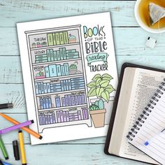 an open book on top of a desk next to a cup of coffee and pencils