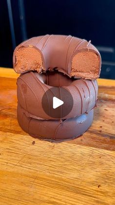 a chocolate bear shaped object sitting on top of a wooden table