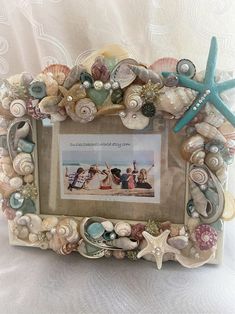 there is a picture frame made out of seashells