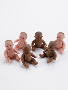 a group of baby dolls sitting next to each other